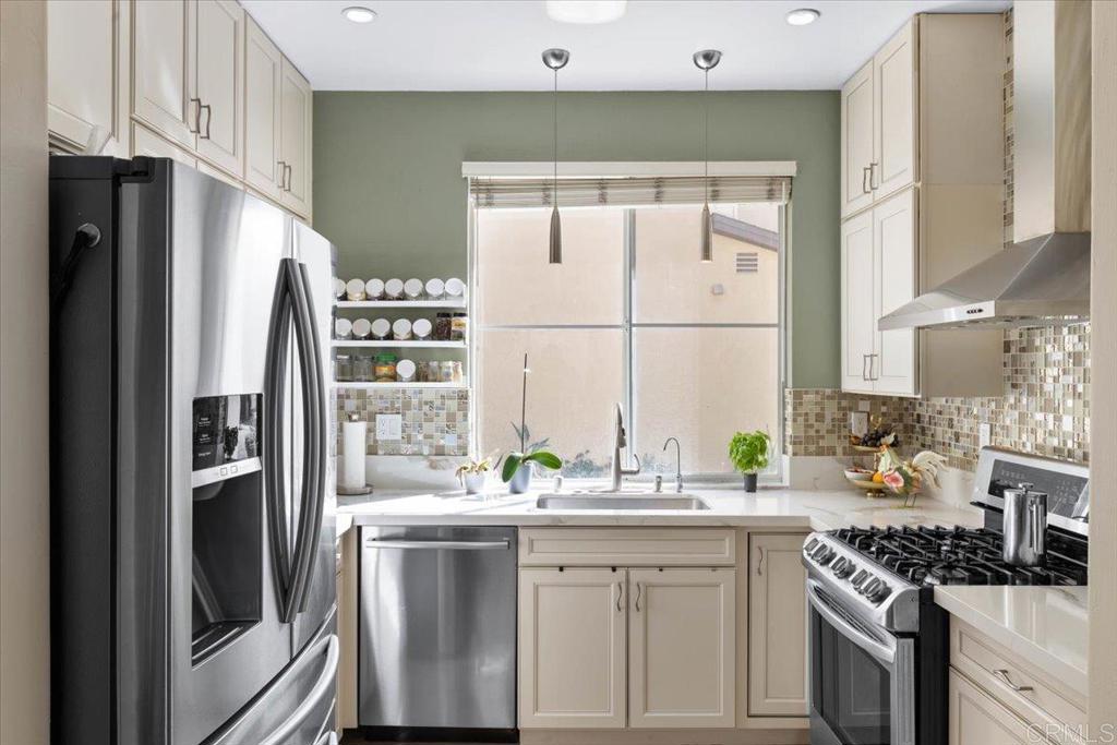 3069 West Canyon Avenue San Diego, CA 92123 - Photo 12 of 37 a kitchen with stainless steel appliances a sink stove and refrigerator