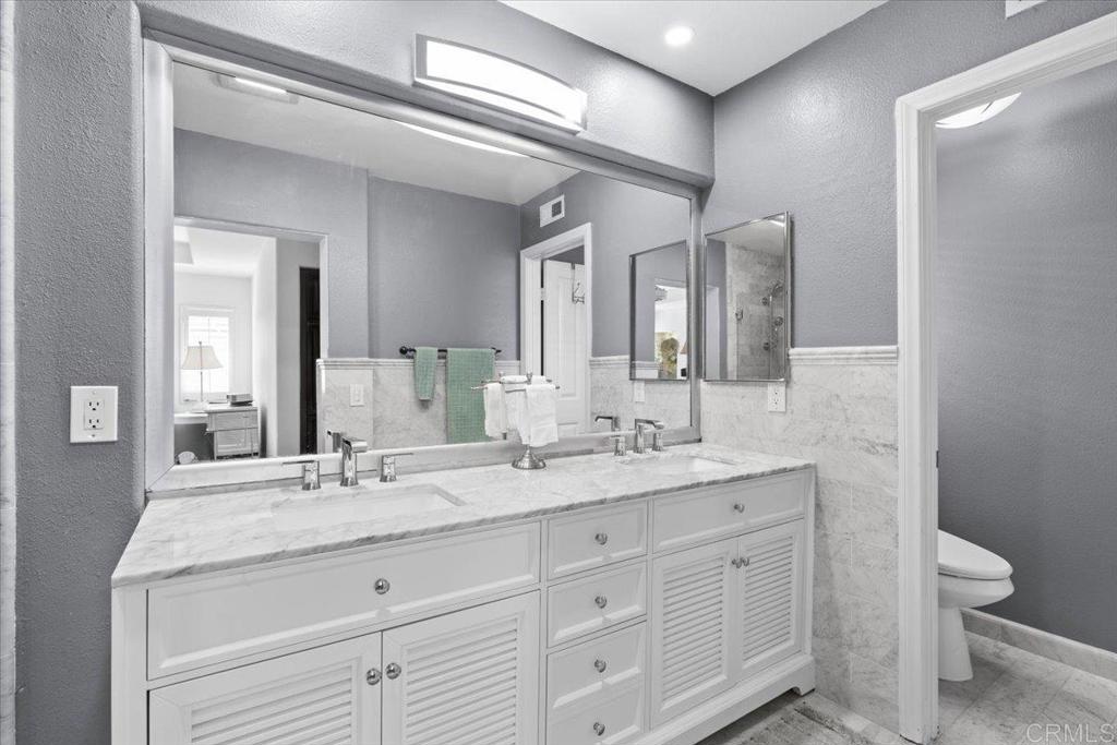 3069 West Canyon Avenue San Diego, CA 92123 - Photo 14 of 37 a bathroom with a granite countertop sink a toilet and a mirror