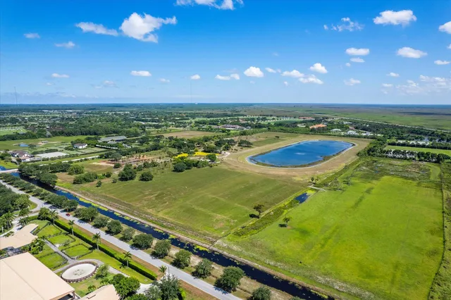 an aerial view of residential houses with outdoor space and swimming pool