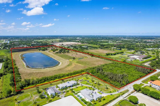 an aerial view of residential houses with outdoor space and city view