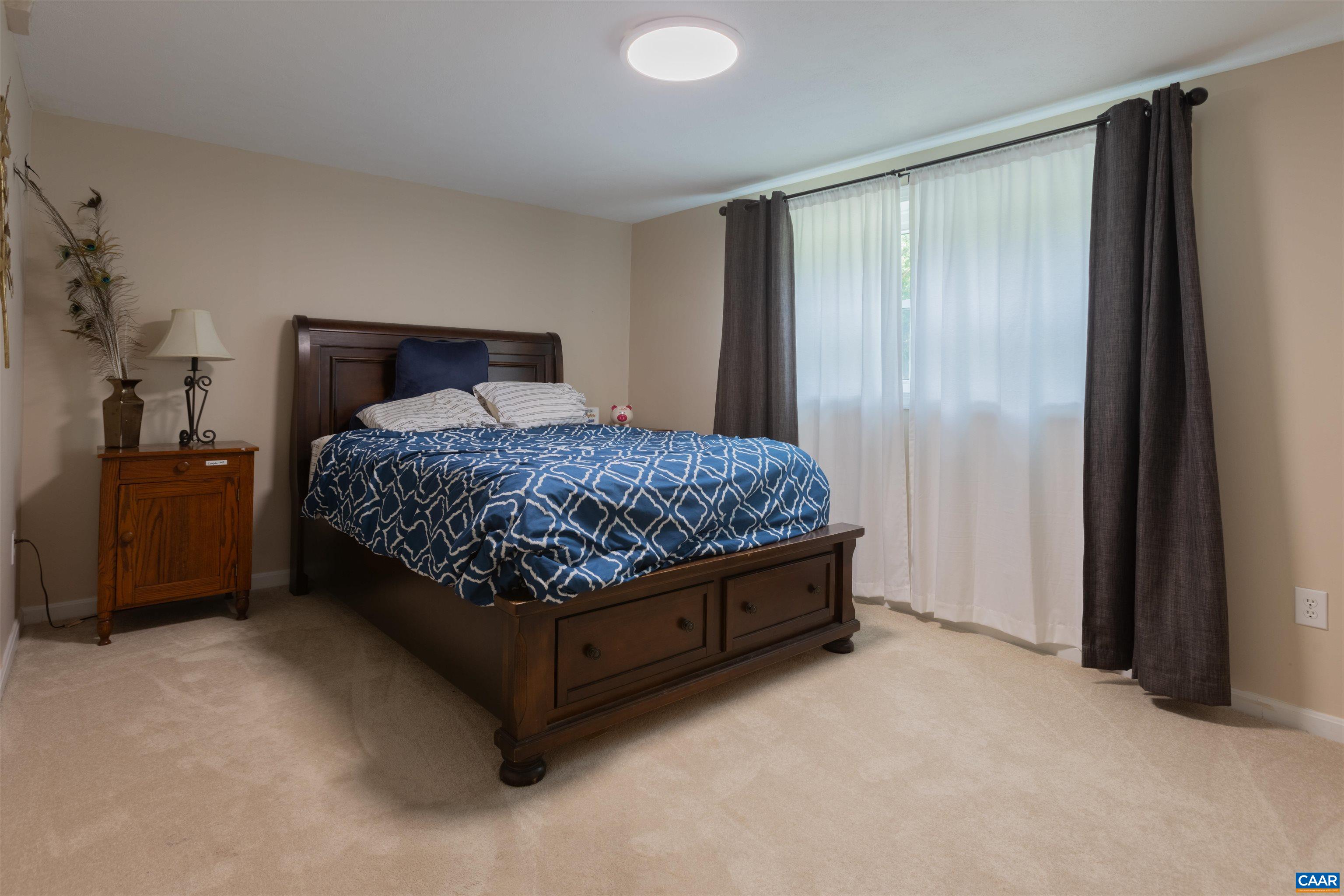 2550 Proffit Road Charlottesville, VA 22911 - Photo 17 of 41 a bed sitting in a bedroom next to a bathroom