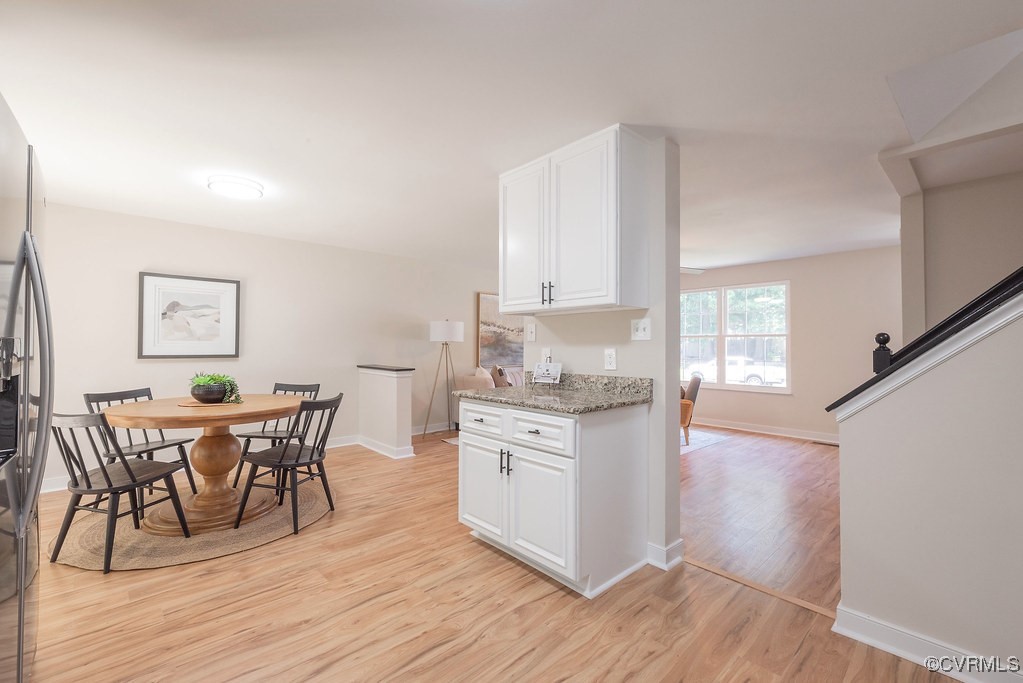 5003 Meredith Woods Road Glen Allen, VA 23060 - Photo 6 of 36 a open kitchen with granite countertop a dining table chairs and white cabinets