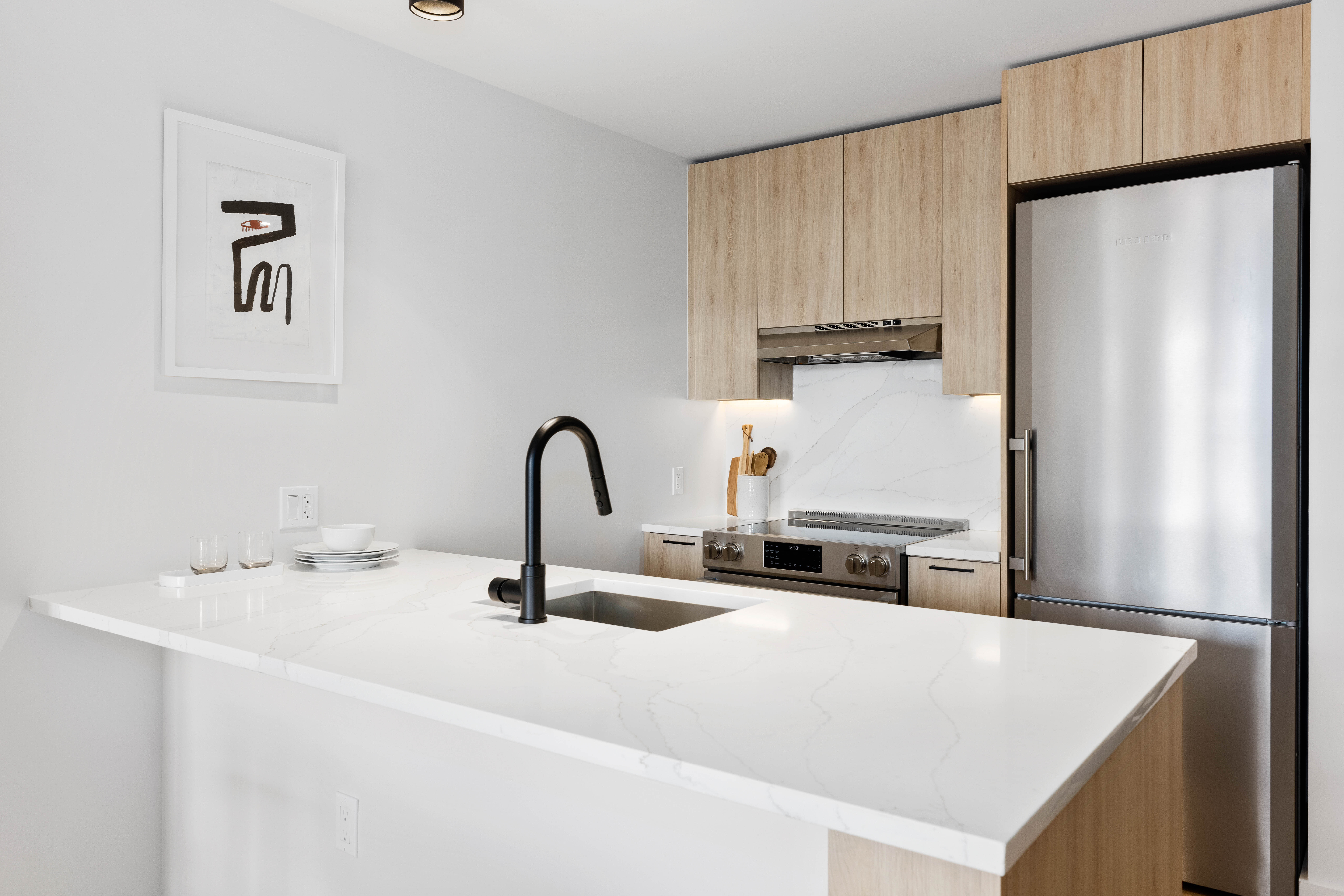 37-05 30th Street, Unit 607 Queens, NY 11106 - Photo 2 of 5 a kitchen with stainless steel appliances a refrigerator sink and cabinets