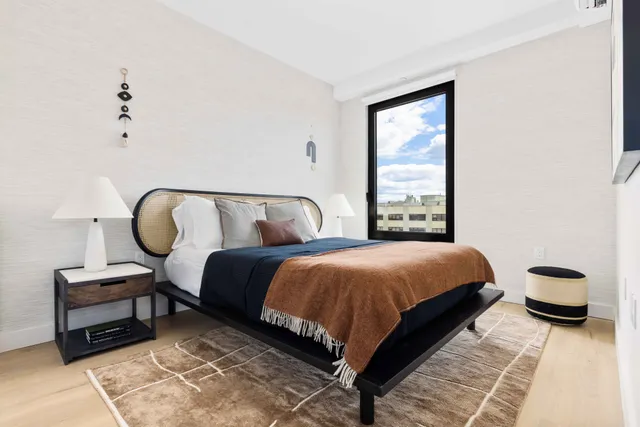 a bedroom with a bed and window