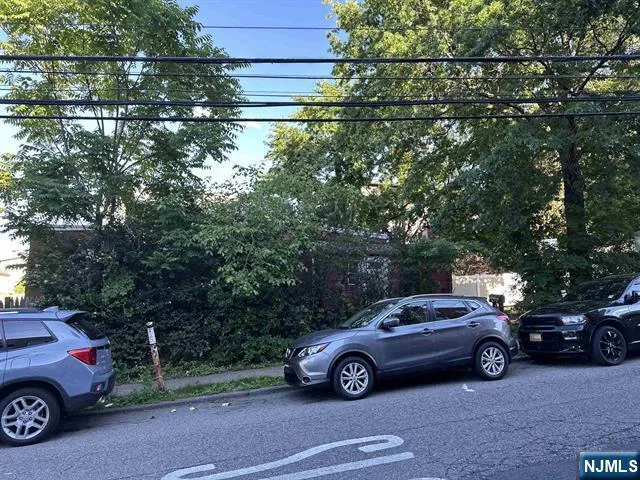 a view of a car parked in front of a house