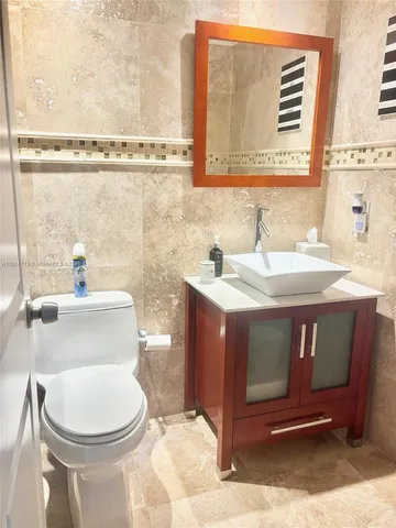 a bathroom with a sink a toilet and mirror