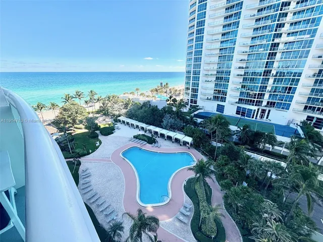 a view of a swimming pool with outdoor seating and plants