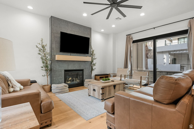 5354 Cyan Lane St. George, UT 84790 - Photo 6 of 45 Living room featuring ceiling fan, a tile fireplace, light wood-type flooring, and recessed lighting