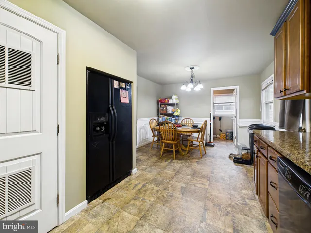 a living room with furniture a dining table and a fireplace