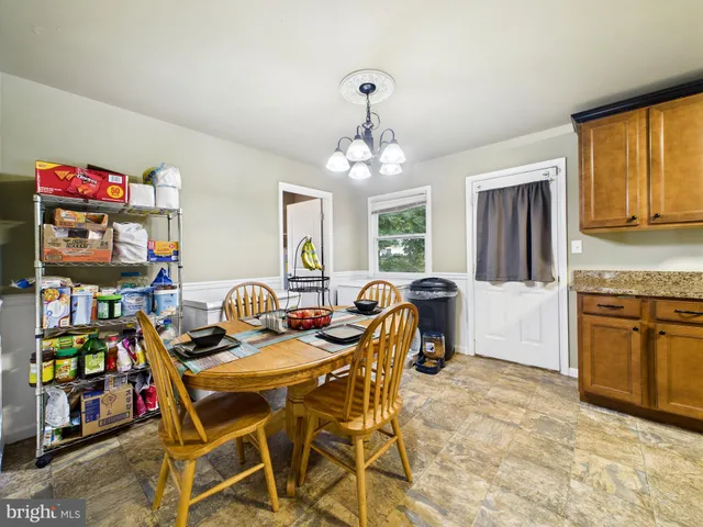 a dining room with furniture and a chandelier