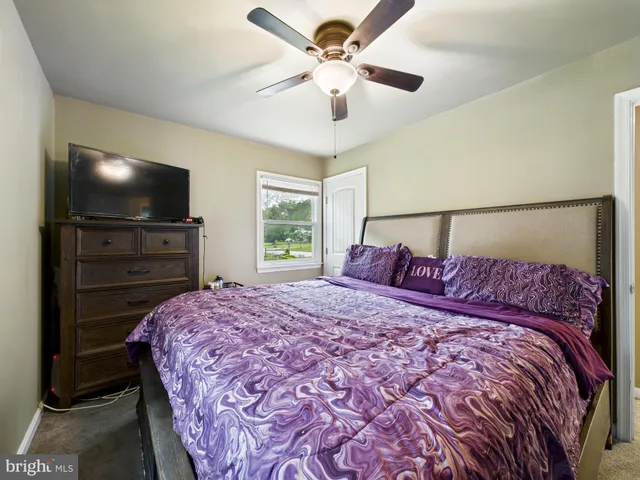 a bed sitting in a bedroom and a flat screen tv