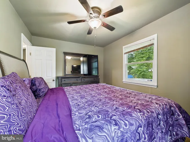 a bedroom with a large bed and a flat screen tv