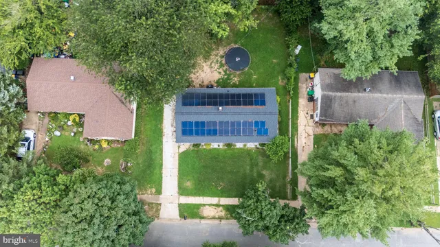 an aerial view of a house with a yard and a garage