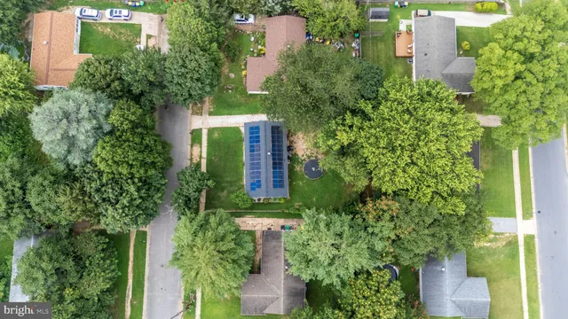 an aerial view of a house with a yard