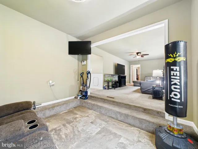 a bedroom with furniture and a flat screen tv