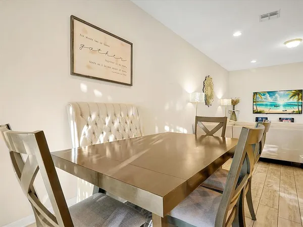 a dining room with furniture and wooden floor