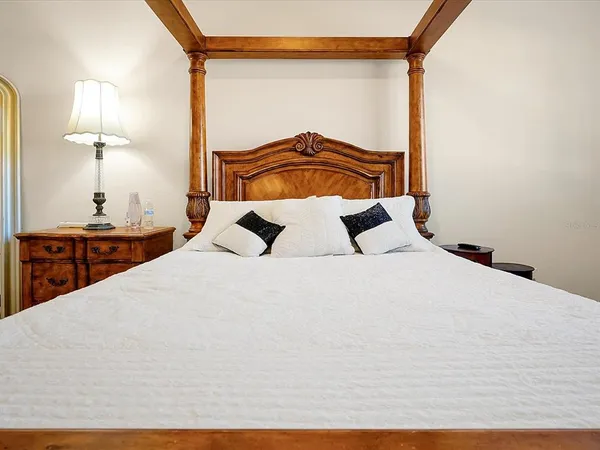 a bedroom with a bed and a night stand