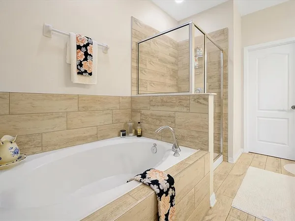 a bathroom with a tub and a shower
