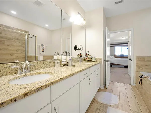 a bathroom with a granite countertop sink mirror and double