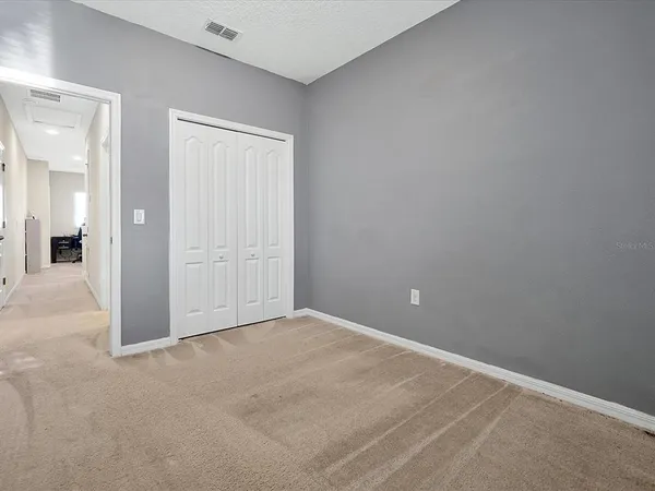 an empty room with closet area