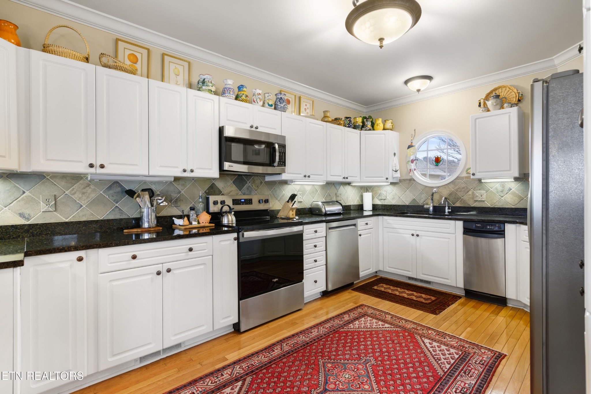 3417 Commodore Point Knoxville, TN 37922 - Photo 12 of 31 a kitchen with granite countertop a sink cabinets and stainless steel appliances
