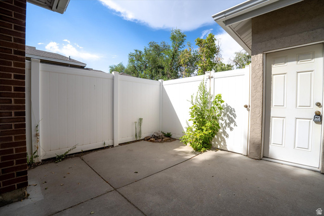 888 East 6895 South Midvale, UT 84047 - Photo 44 of 54 Quiet, fenced outdoor area with direct access to the home, offering a comfortable and secluded setting.