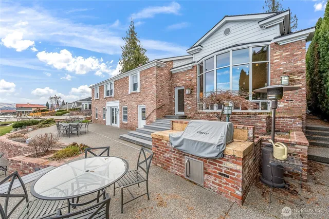 a front view of a house with a yard and potted plants