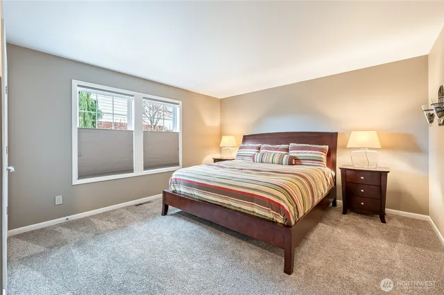 a bedroom with a bed and a lamp