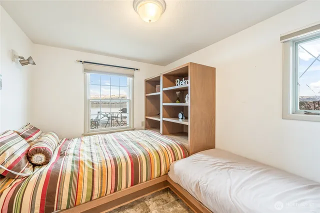 a bathroom with a granite countertop tub sink and mirror
