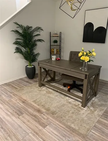 a view of a hallway with wooden floor and stairs