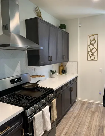 a kitchen with stainless steel appliances a stove a sink and a refrigerator