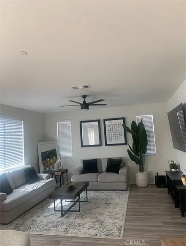 a living room with furniture and wooden floor