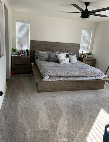 a spacious bedroom with a bed and a window