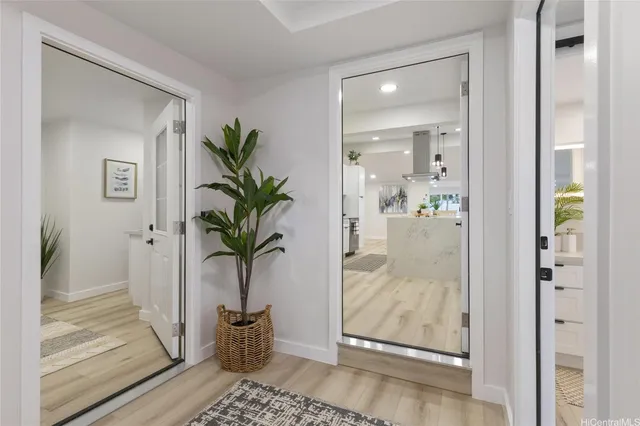 a view of a hallway that has a glass door and front door
