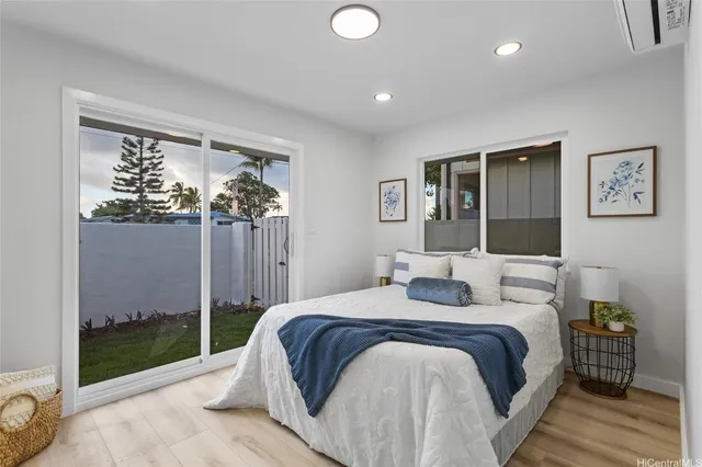 a bedroom with a large bed and a chandelier