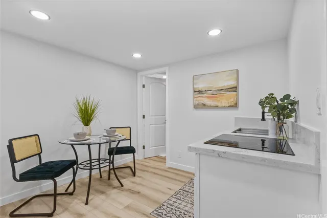 a view of a livingroom with furniture and a potted plant