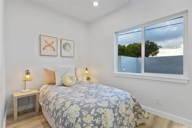 a bedroom with a large bed and a window