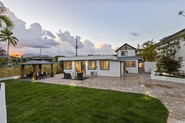 a view of a house with a yard porch and sitting area