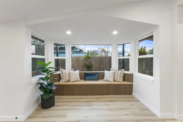 a living room with furniture and a potted plant