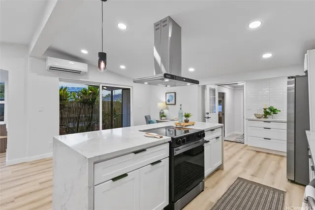 a kitchen with granite countertop a sink and stove in it