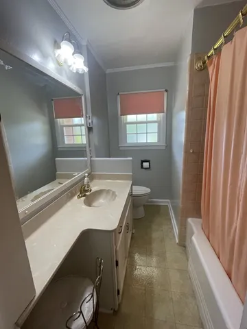 a bathroom with a sink a vanity and a mirror