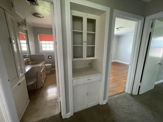 a view of a hallway and a livingroom with furniture