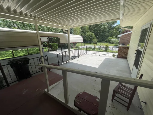 a view of a patio with table and chairs potted plants with wooden floor