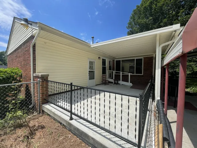 a view of a house with backyard and porch