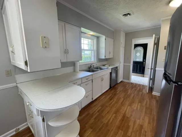 a spacious bathroom with a double vanity sink a mirror and a bathtub