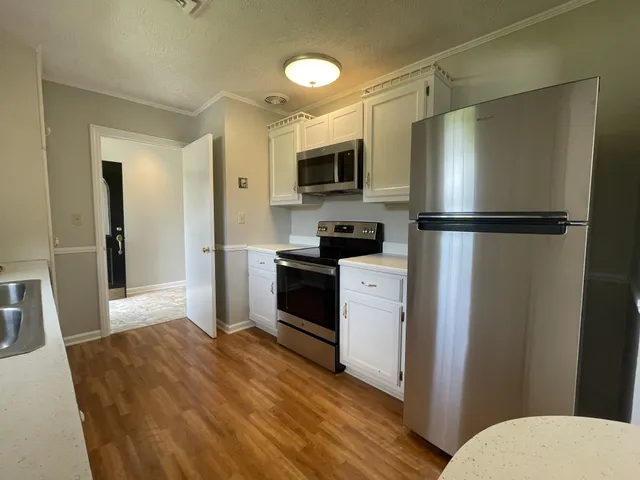 a kitchen with a refrigerator a sink and a stove