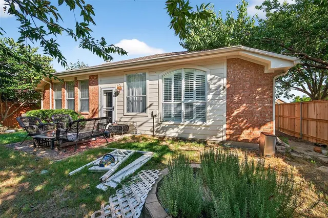 a backyard of a house with yard and outdoor seating