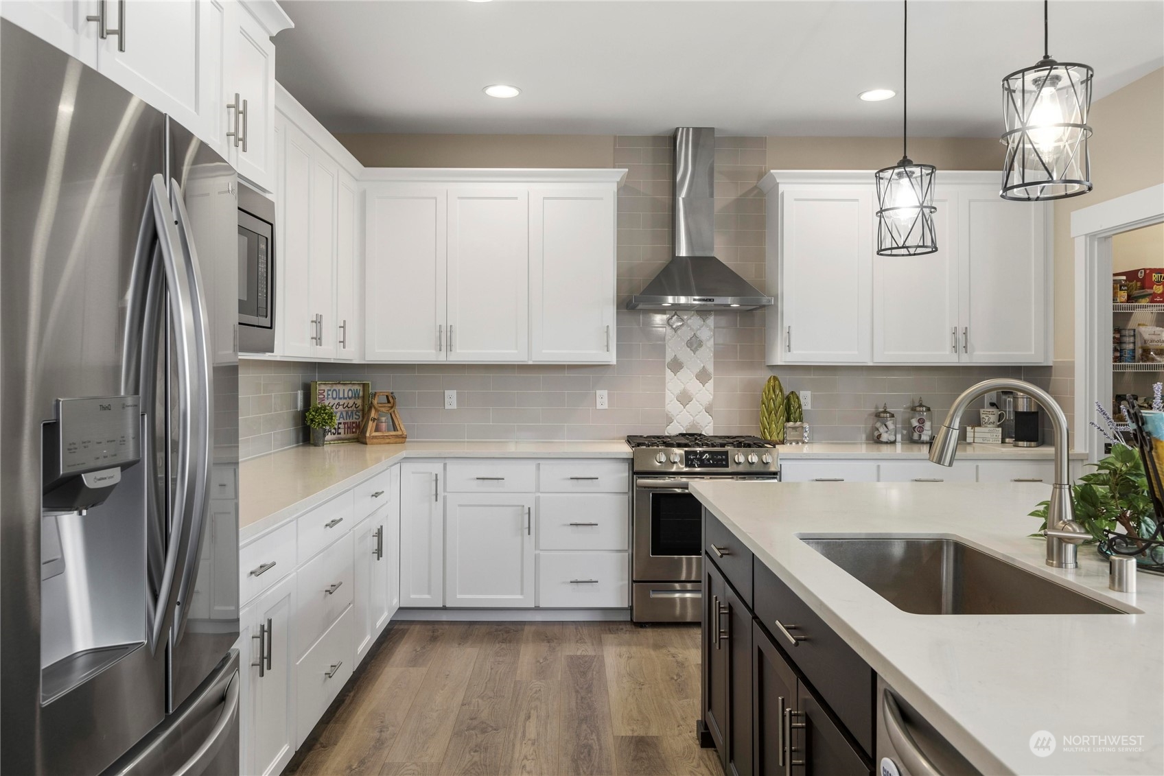 111 Love Drive Enumclaw, WA 98022 - Photo 12 of 34 a kitchen with stainless steel appliances granite countertop a sink dishwasher a refrigerator and a stove with wooden floor
