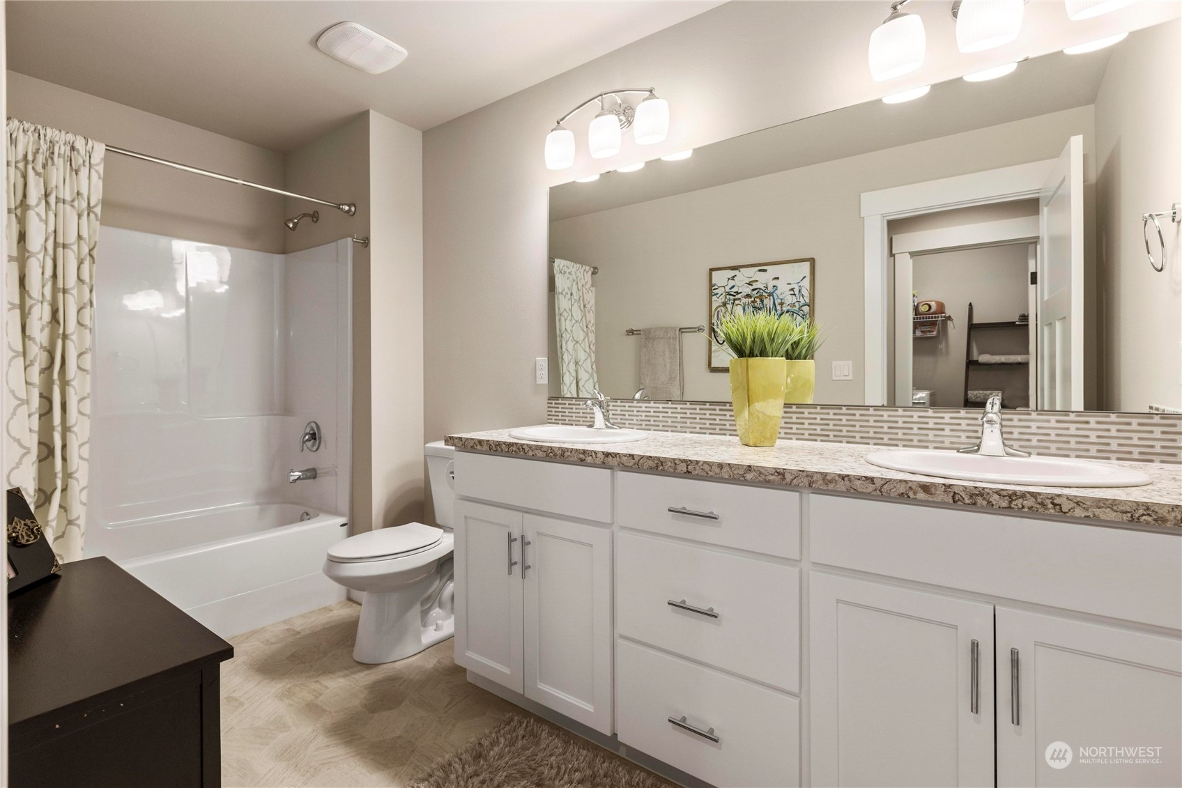 111 Love Drive Enumclaw, WA 98022 - Photo 25 of 34 a bathroom with a granite countertop sink toilet a large mirror a bathtub and shower