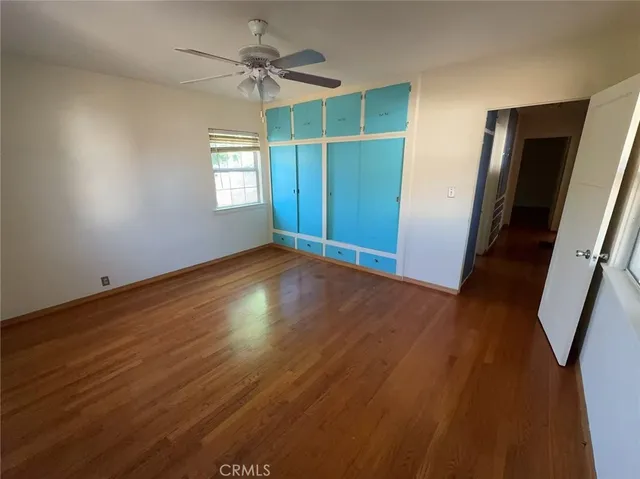 a view of hallway with stairs and wooden floor